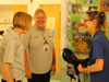 Three Nurses in Demelza clothing looking at each other and smiling in a hallway