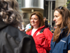A Demelza staff member talking to a woman in a red coat