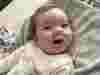 A young boy with a ventilator in his nose smiling