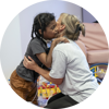 A Demelza HCA hugging a child