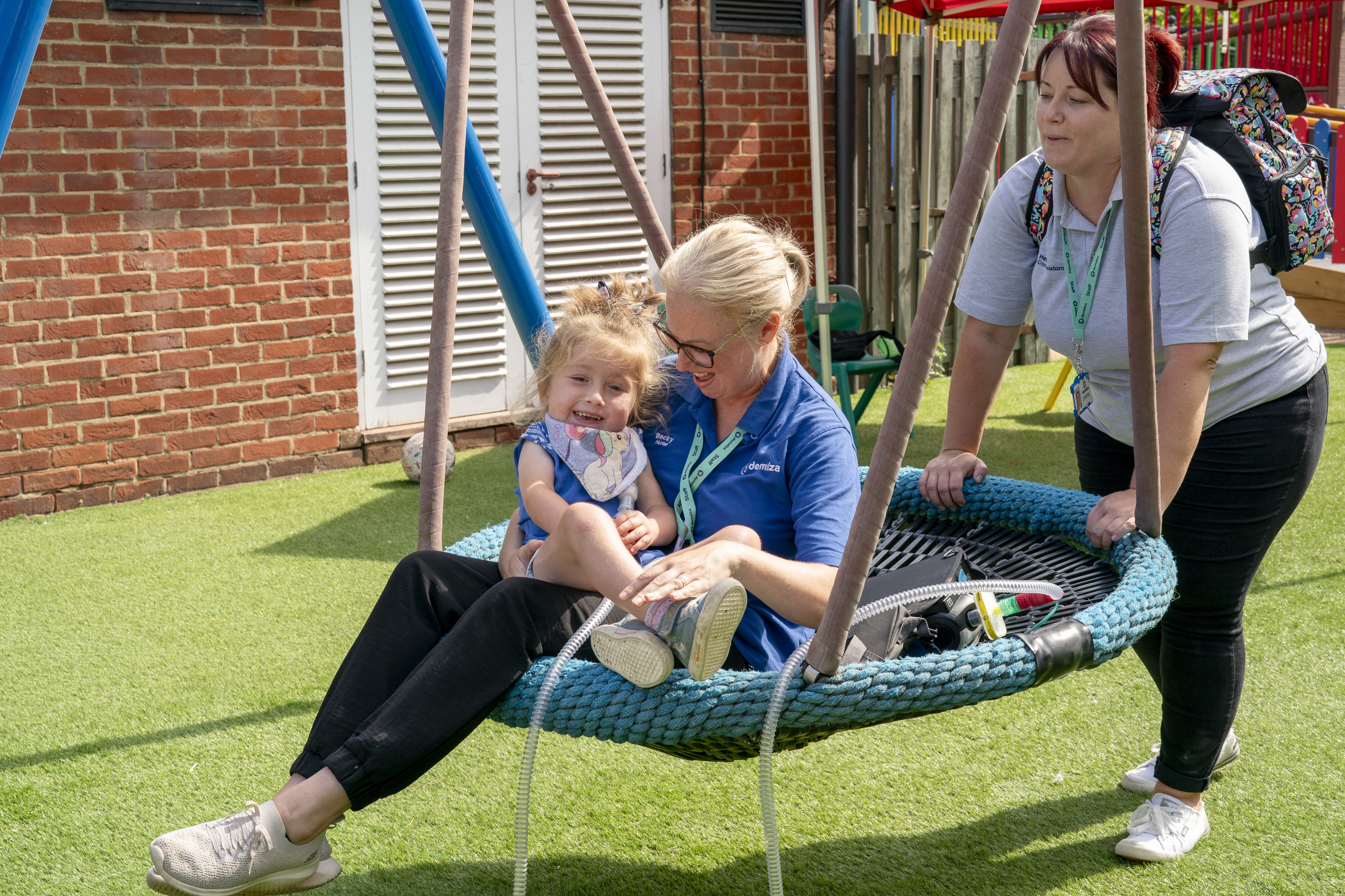 Nurse and child on swing