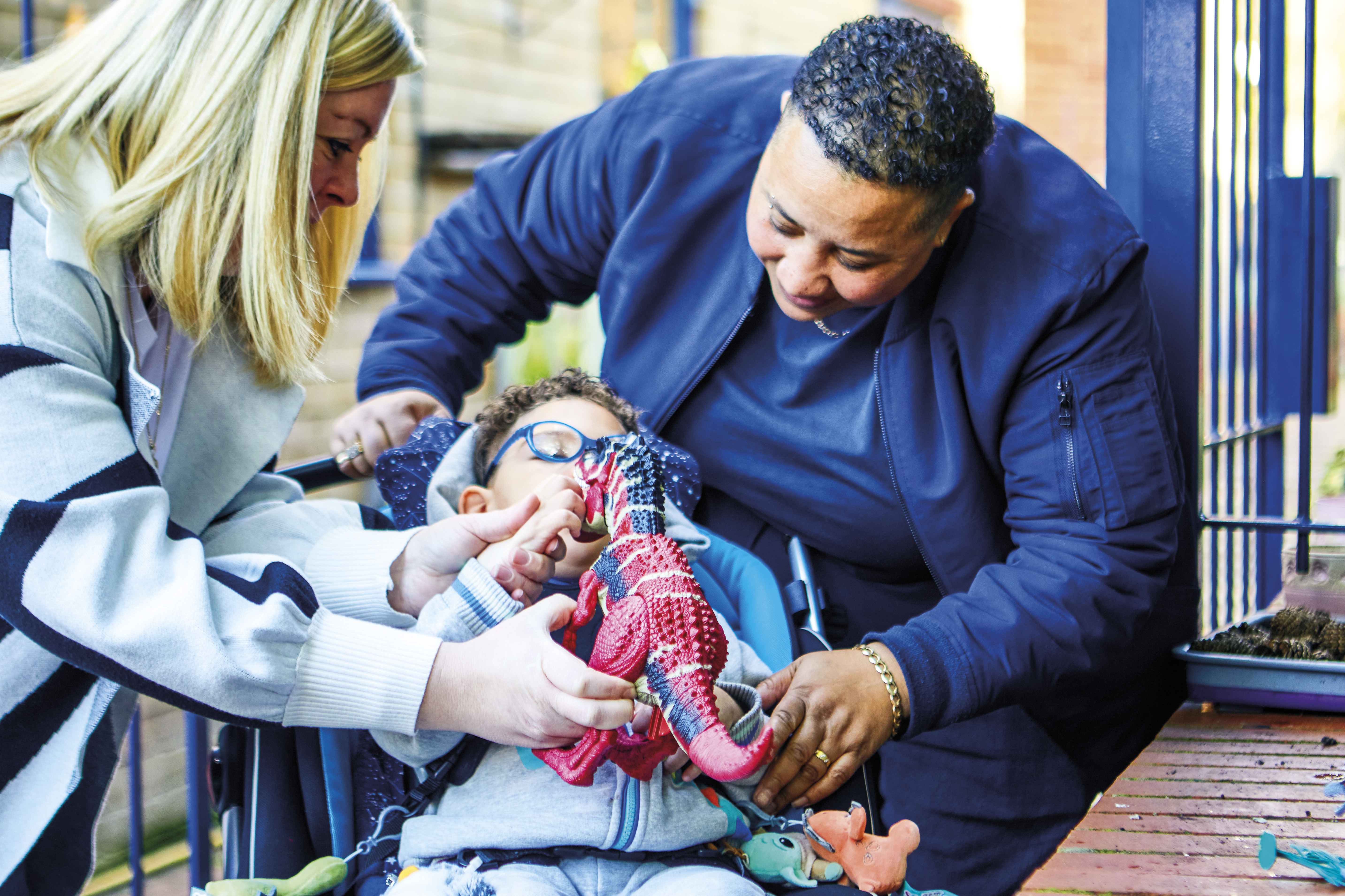 Child and family with dinosaur toy