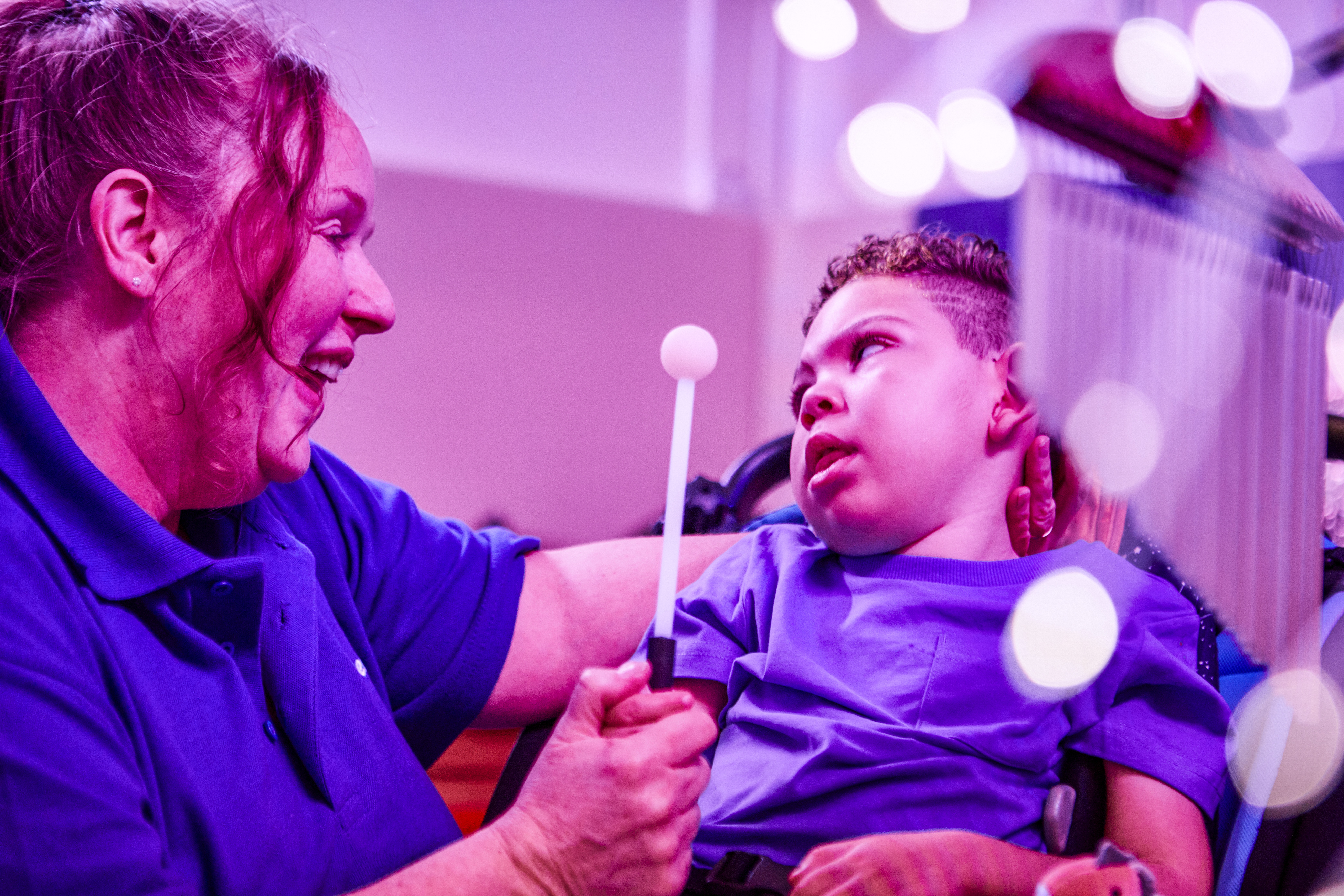 Image of sensory play with child and staff