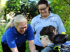 A Demelza nurse and health care assistant on a community outing with a young boy