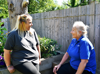Two women with blonde hair chatting in the garden at East Sussex