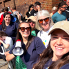 A group of five women smiling towards the camera in Demelza uniform who are out supporting runners at the London Marathon 2025