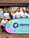 Corporate team with Demelza branded sign