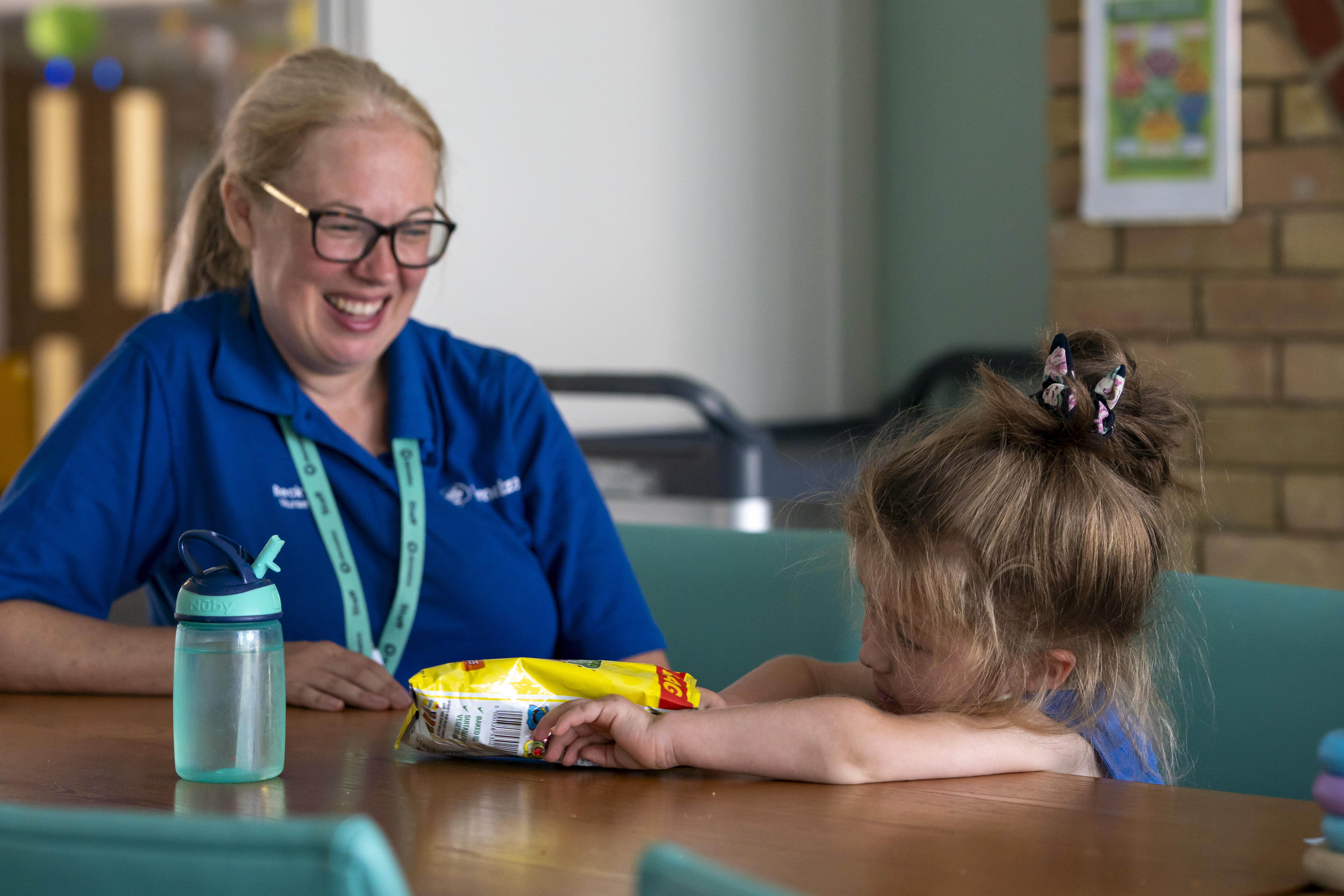 Nurse and child together in kitchen