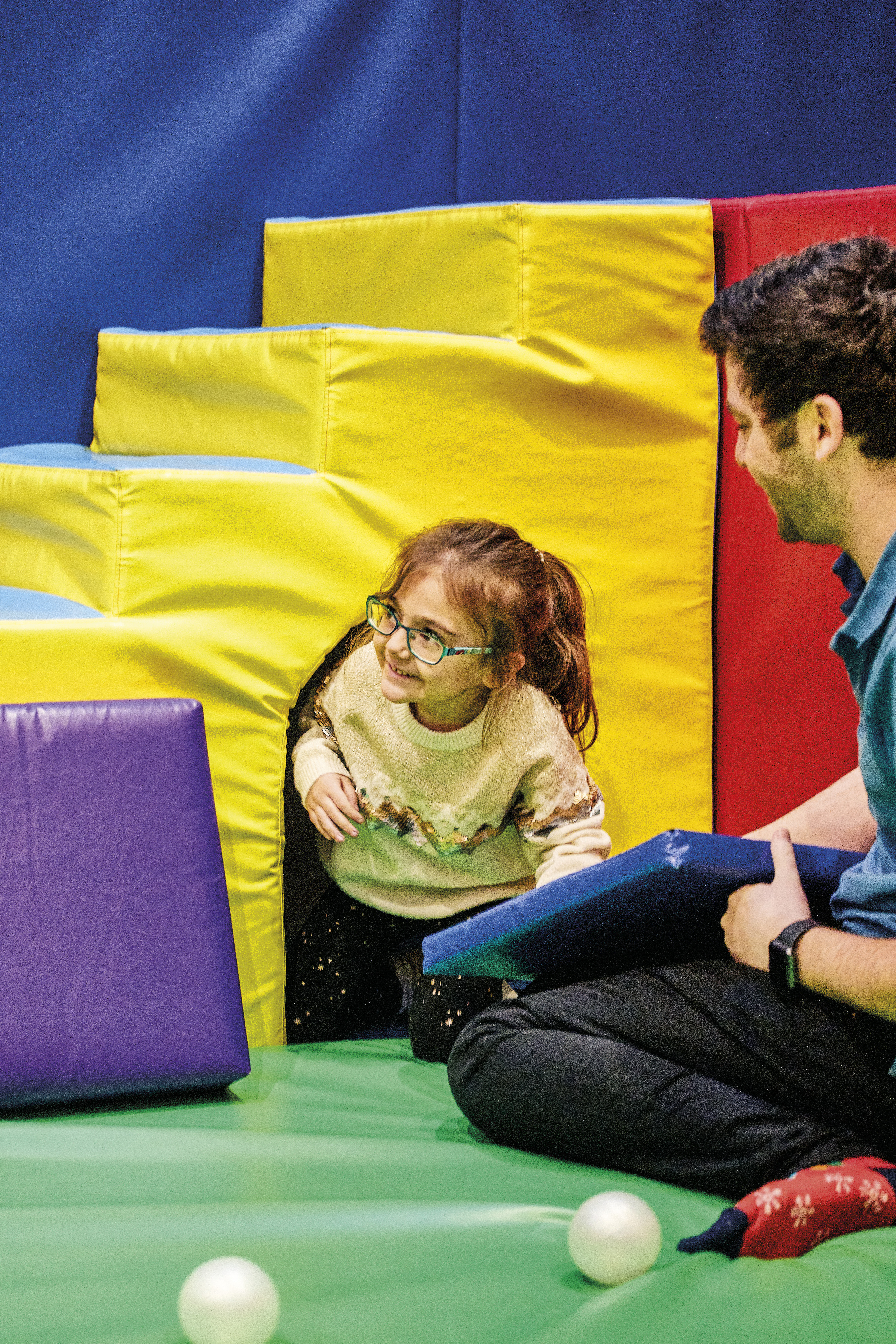 Image of child crawling through the soft play area at Demelza