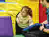 Image of child crawling through the soft play area at Demelza
